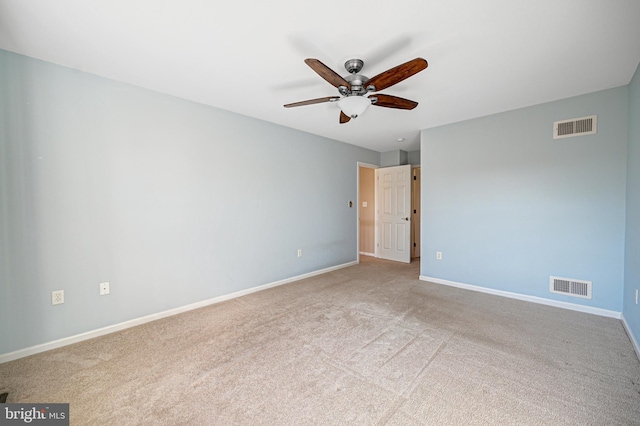 carpeted spare room with ceiling fan