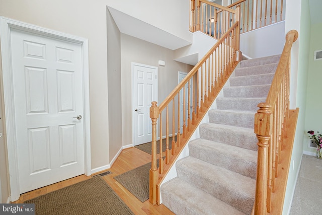 stairs featuring hardwood / wood-style floors