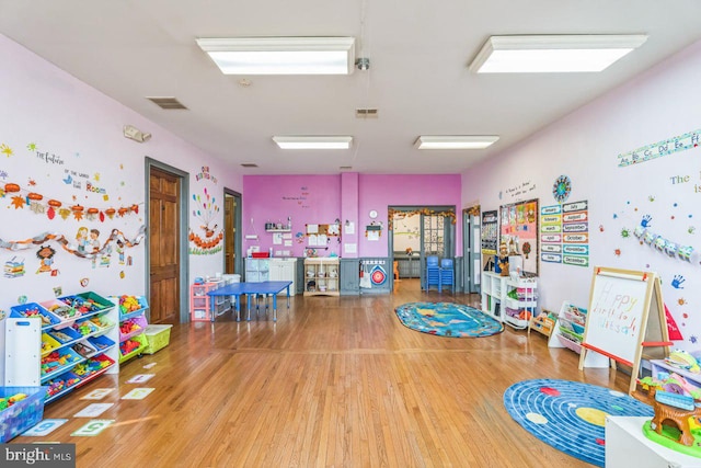 playroom with hardwood / wood-style flooring