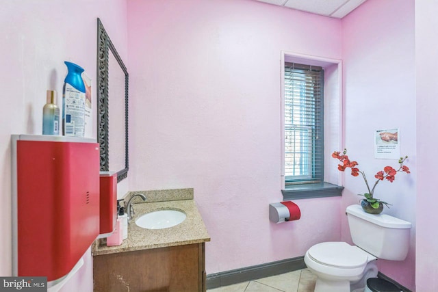 bathroom featuring tile patterned flooring, vanity, and toilet