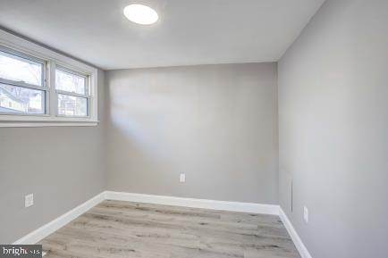 spare room with light wood-type flooring