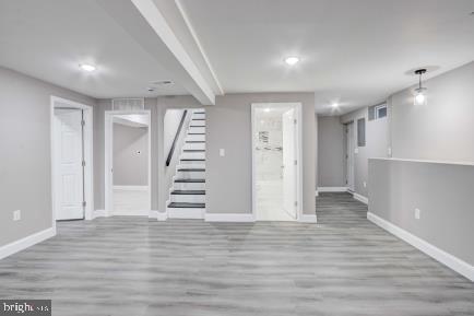 basement with light hardwood / wood-style floors