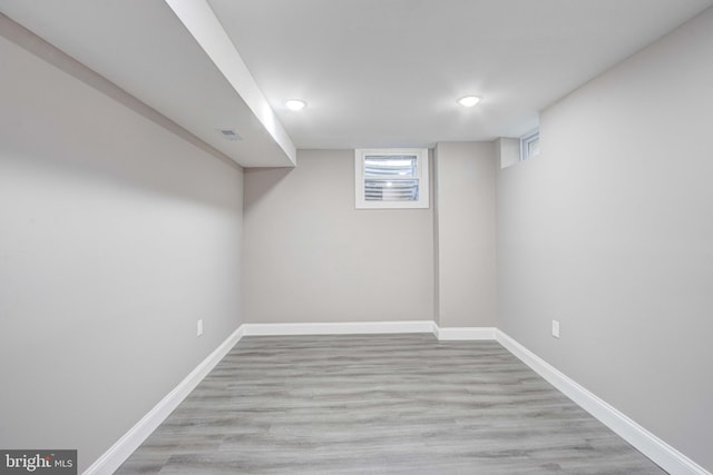 basement with light hardwood / wood-style floors