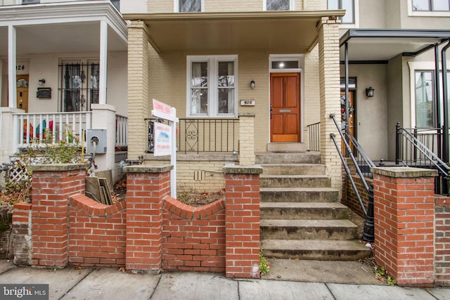 doorway to property featuring covered porch