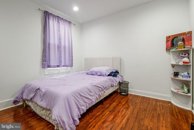 bedroom with hardwood / wood-style flooring