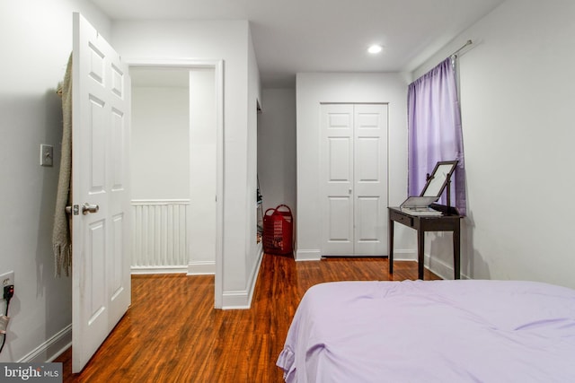 bedroom featuring dark wood-type flooring and a closet