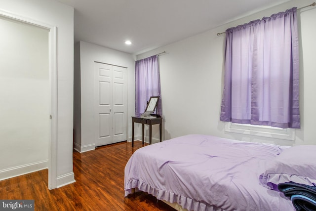 bedroom featuring dark hardwood / wood-style floors and a closet