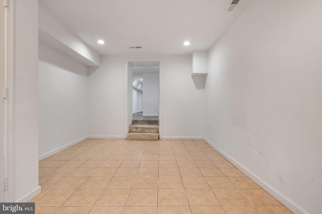 basement featuring light tile patterned flooring