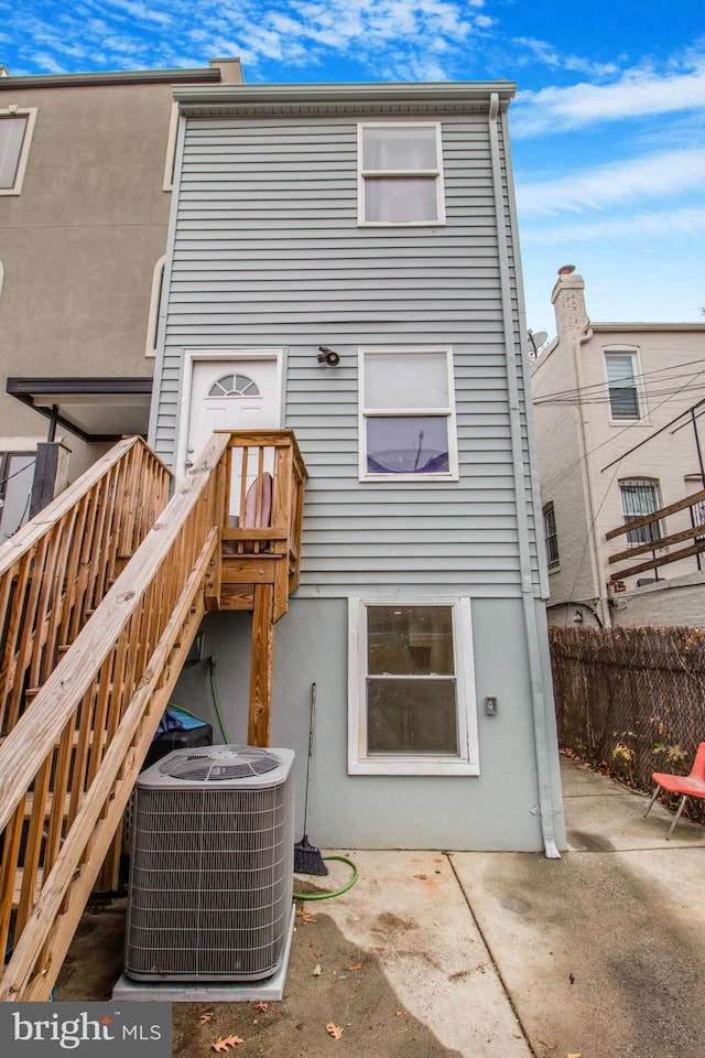 back of property featuring central air condition unit