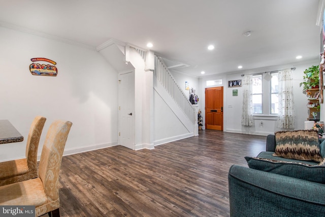 living room with crown molding and dark wood-type flooring