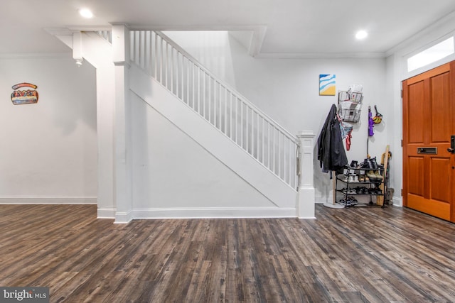 foyer with dark hardwood / wood-style floors and ornamental molding