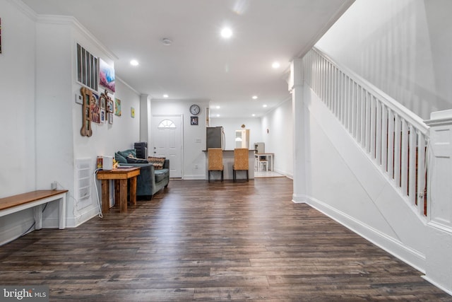 living room featuring dark wood-type flooring and ornamental molding