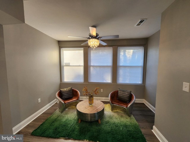 living area featuring dark hardwood / wood-style floors and ceiling fan