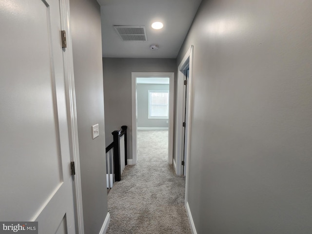 corridor featuring light colored carpet