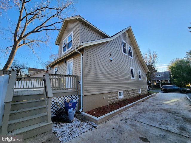 view of home's exterior featuring a wooden deck