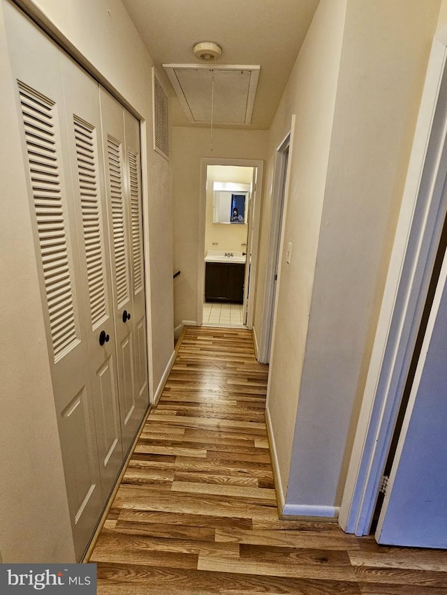 hall with hardwood / wood-style flooring