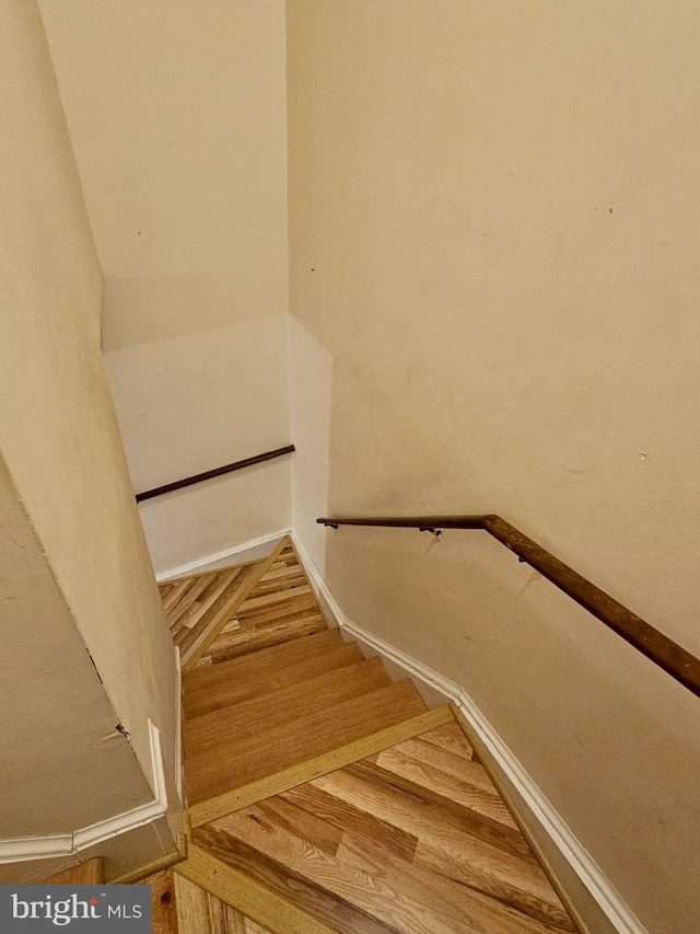 stairs with hardwood / wood-style flooring