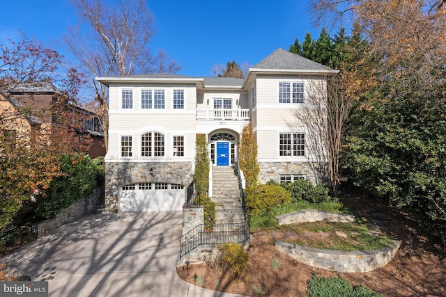 view of front of house with a garage and a balcony