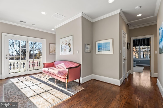 living area with dark wood-type flooring and ornamental molding