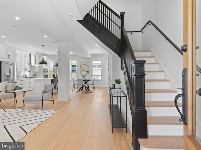 stairway featuring wood-type flooring