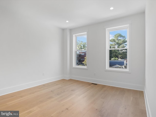 spare room with light hardwood / wood-style floors