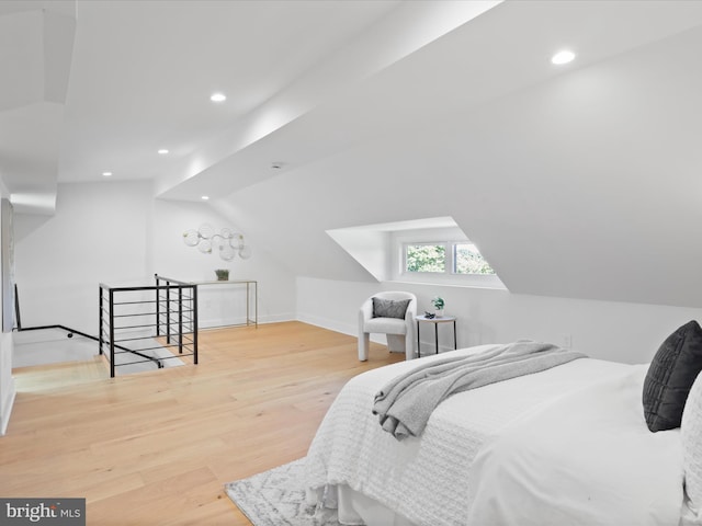 bedroom with wood-type flooring and lofted ceiling