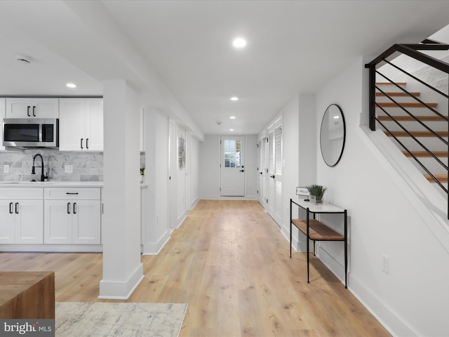 interior space with sink and light hardwood / wood-style flooring