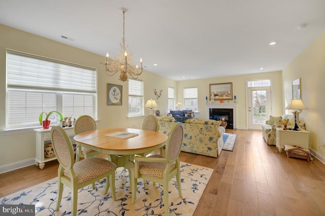 dining room with a notable chandelier and light hardwood / wood-style floors