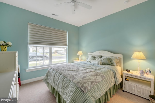 bedroom with ceiling fan and light carpet