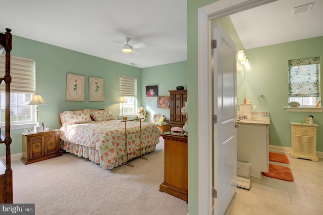 bedroom with light colored carpet, multiple windows, and ceiling fan