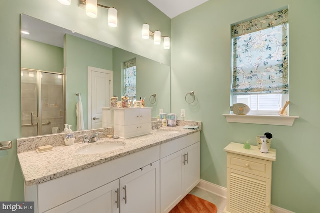 bathroom with vanity and a shower with shower door