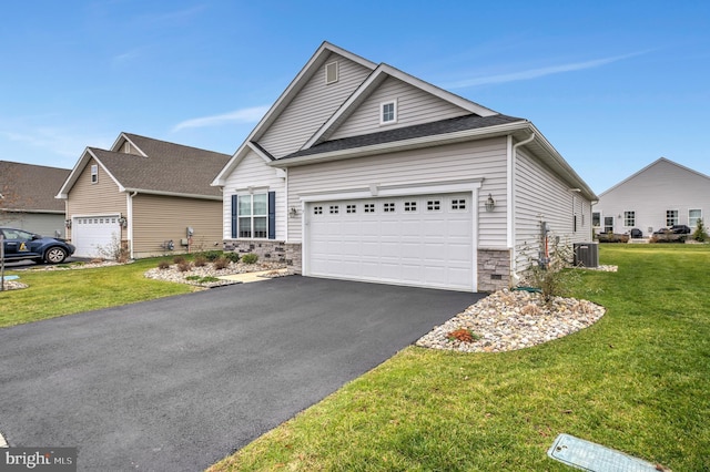 view of front of home with a front lawn and central AC