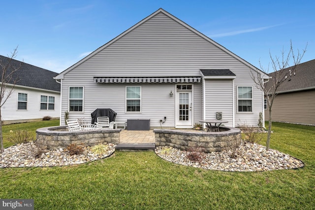 back of house featuring a patio area and a yard