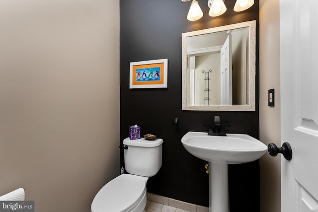 bathroom featuring tile patterned flooring and toilet