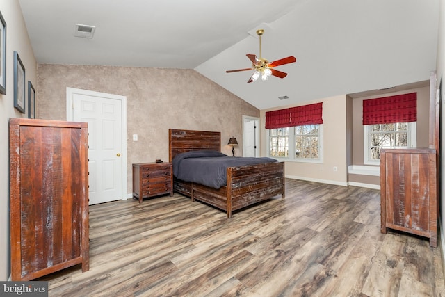 bedroom featuring hardwood / wood-style floors, ceiling fan, and lofted ceiling