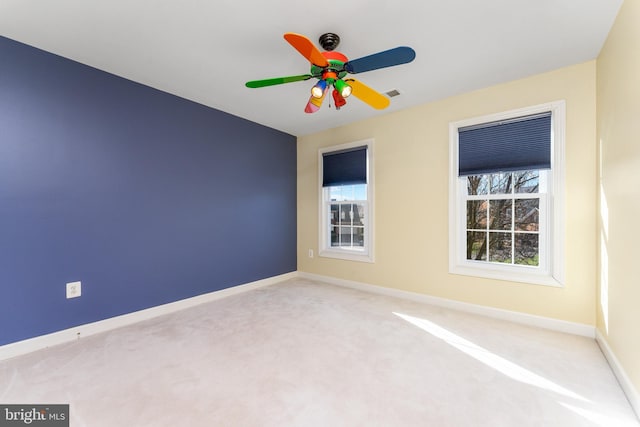 unfurnished room with ceiling fan, plenty of natural light, and carpet floors