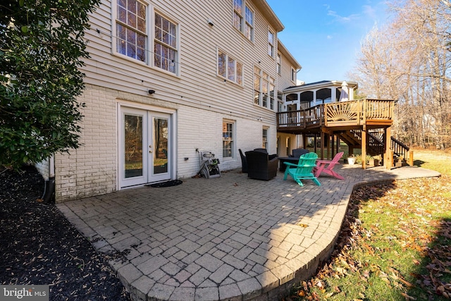 back of property featuring a deck, a patio, and french doors