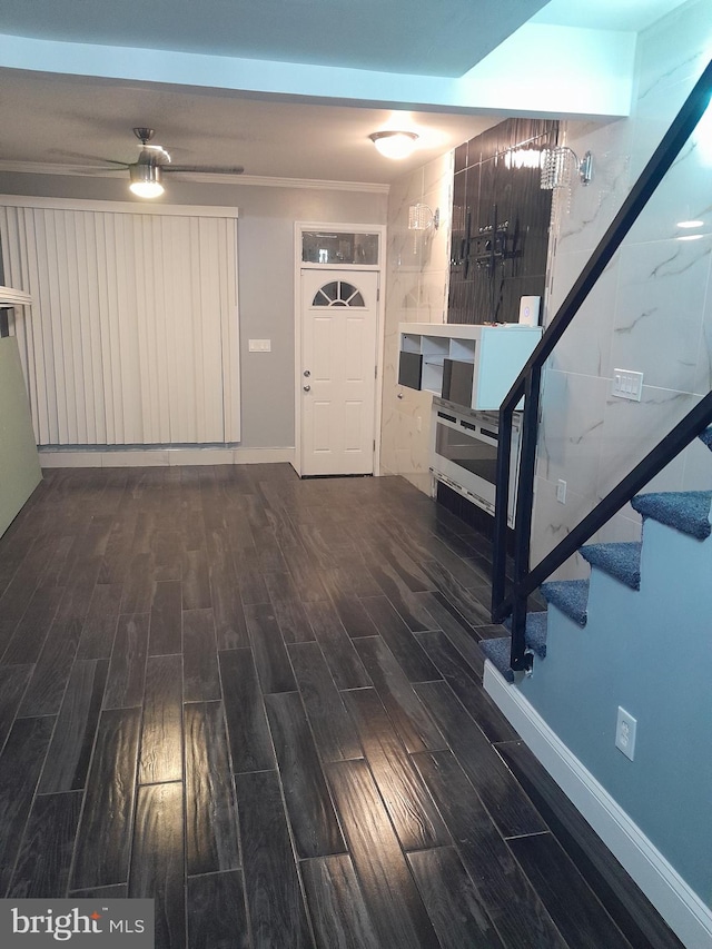 foyer entrance with dark hardwood / wood-style flooring and ceiling fan