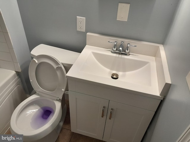 bathroom featuring tile patterned floors, vanity, and toilet