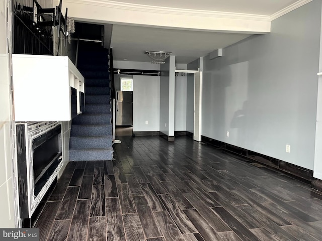 120 S Haven St, Baltimore, MD 21224 - unfurnished living room featuring wood finished floors, stairway, baseboards, ornamental molding, and a barn door