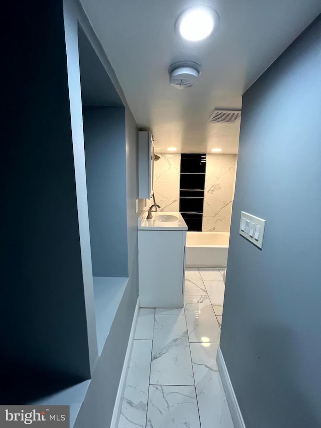 120 S Haven St, Baltimore, MD 21224 - hallway featuring light marble finish flooring, a sink, and baseboards