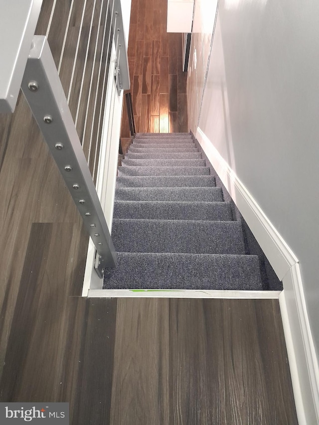 stairs with hardwood / wood-style flooring