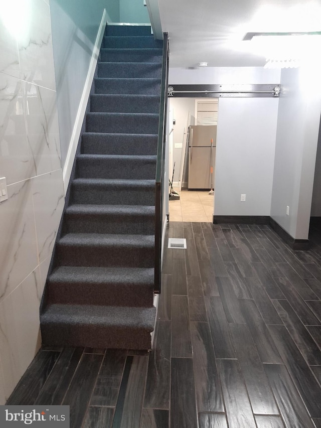 stairway with hardwood / wood-style flooring