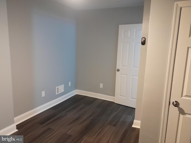 spare room featuring dark hardwood / wood-style flooring