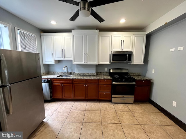 120 S Haven St, Baltimore, MD 21224 - kitchen with appliances with stainless steel finishes, a sink, a ceiling fan, light stone countertops, and white cabinets