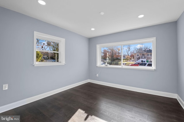 unfurnished room with dark hardwood / wood-style floors