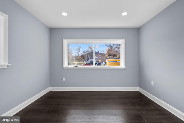 unfurnished room featuring dark wood-type flooring