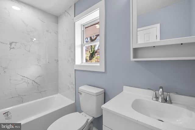 full bathroom with vanity, toilet, and tiled shower / bath combo