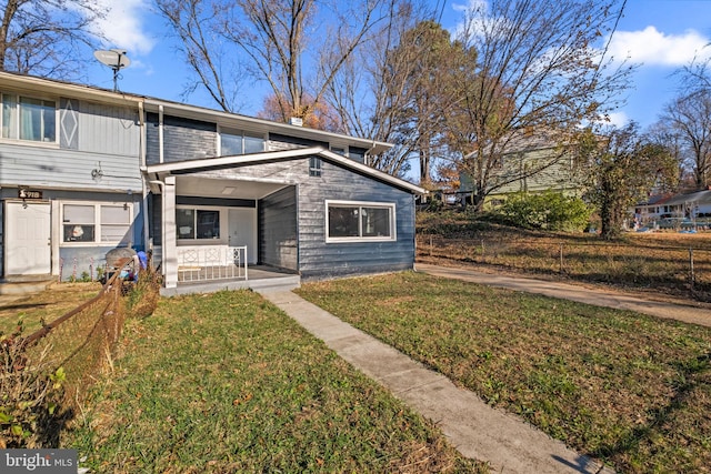 view of front of home with covered porch and a front lawn