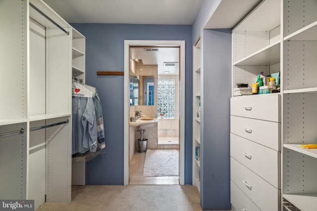 walk in closet featuring light tile patterned flooring